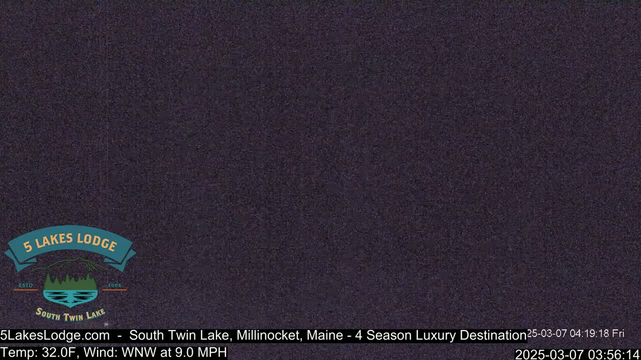 A dark, grainy image shows a mostly obscured nighttime view with a 32°F temperature and a 9.0 mph wind from the west-northwest.