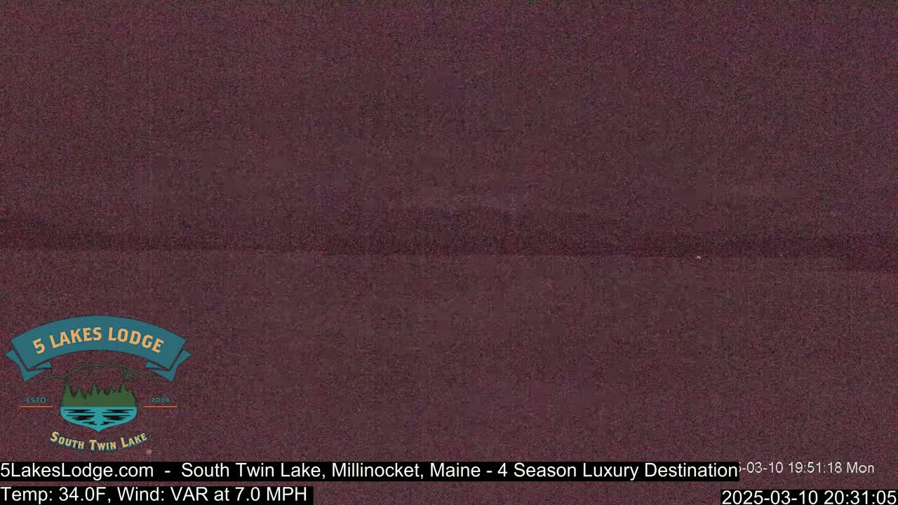 A dark, possibly nighttime, view of a calm body of water.
