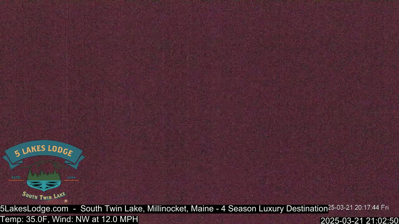 A dark purple, grainy image shows a mostly-clear night sky.
