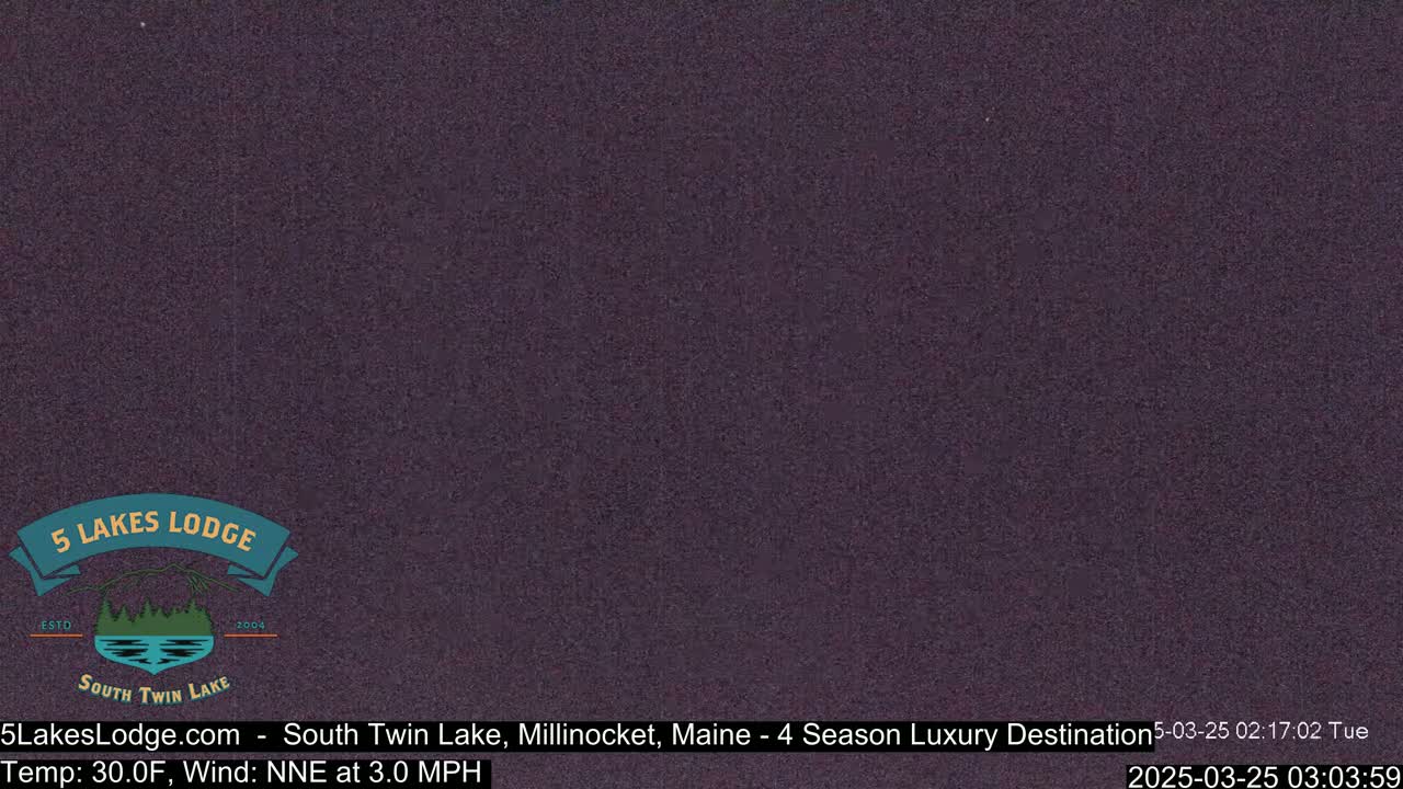 A dark purple, grainy image shows a nighttime or low-light outdoor scene with a temperature of 30 degrees Fahrenheit and a wind from the north-northeast at 3.0 miles per hour.
