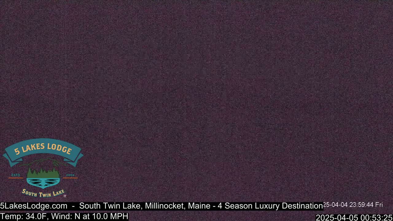 A dark purple screen displays a snowy or nighttime scene with a 34°F temperature and a 10 mph north wind.