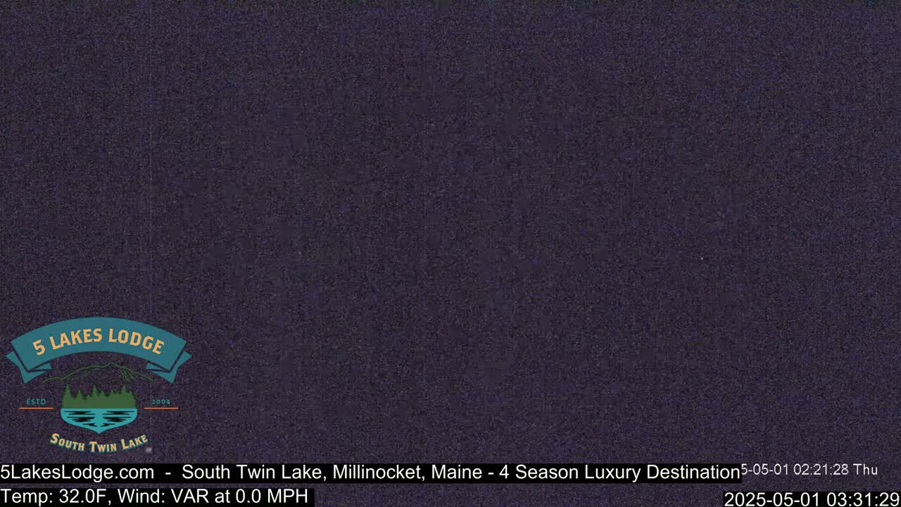 A dark purple-gray image shows a nighttime outdoor scene with calm, windless conditions.