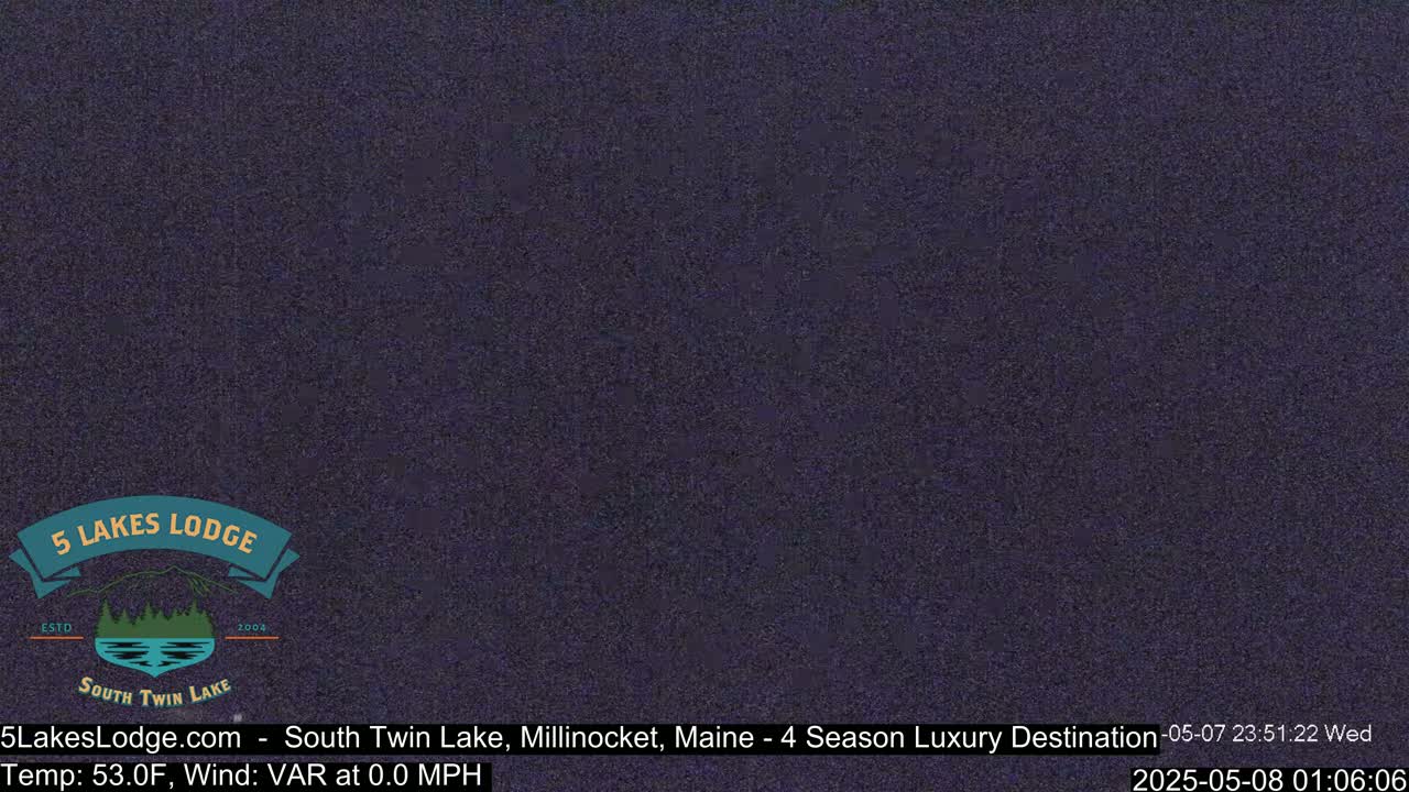 A dark, nighttime view of a seemingly still body of water.