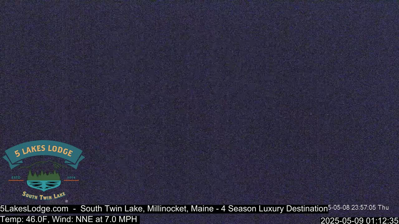 A dark, nighttime image of a lake shows a mostly clear, dark sky with a 46°F temperature and a 7.0 mph north-northeast wind.
