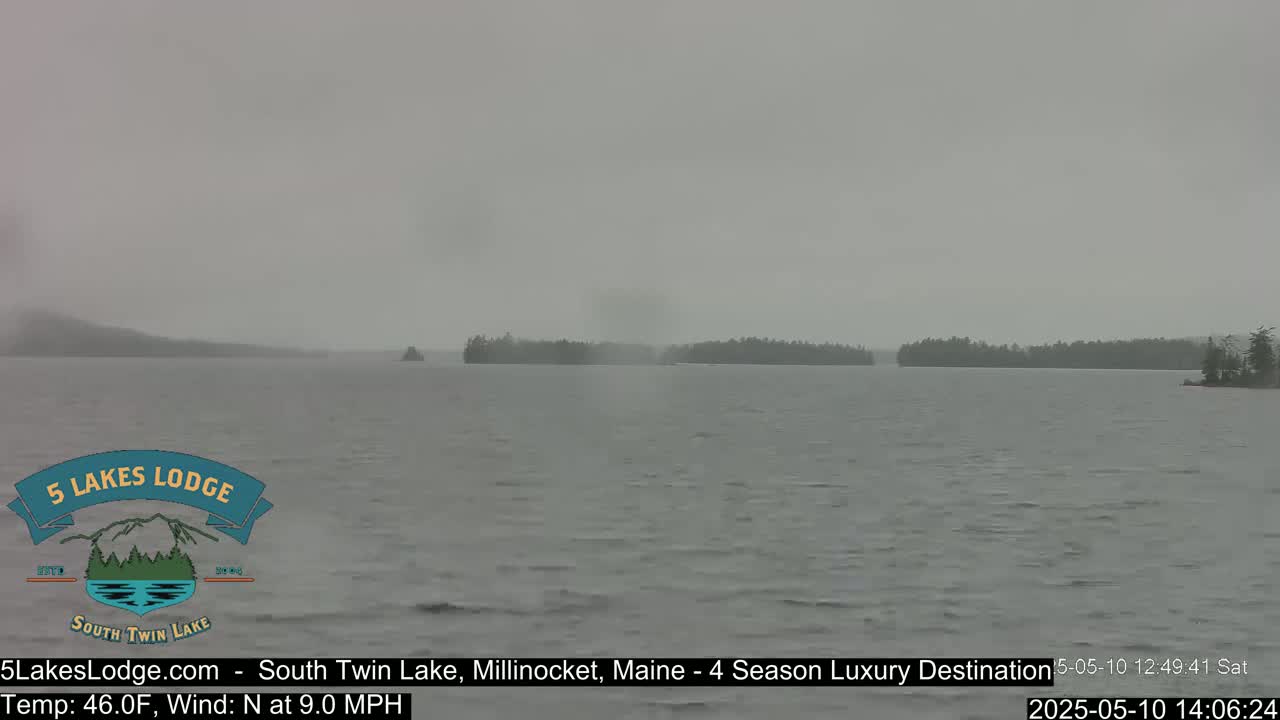 A foggy, overcast view of a lake with wooded islands in the distance.
