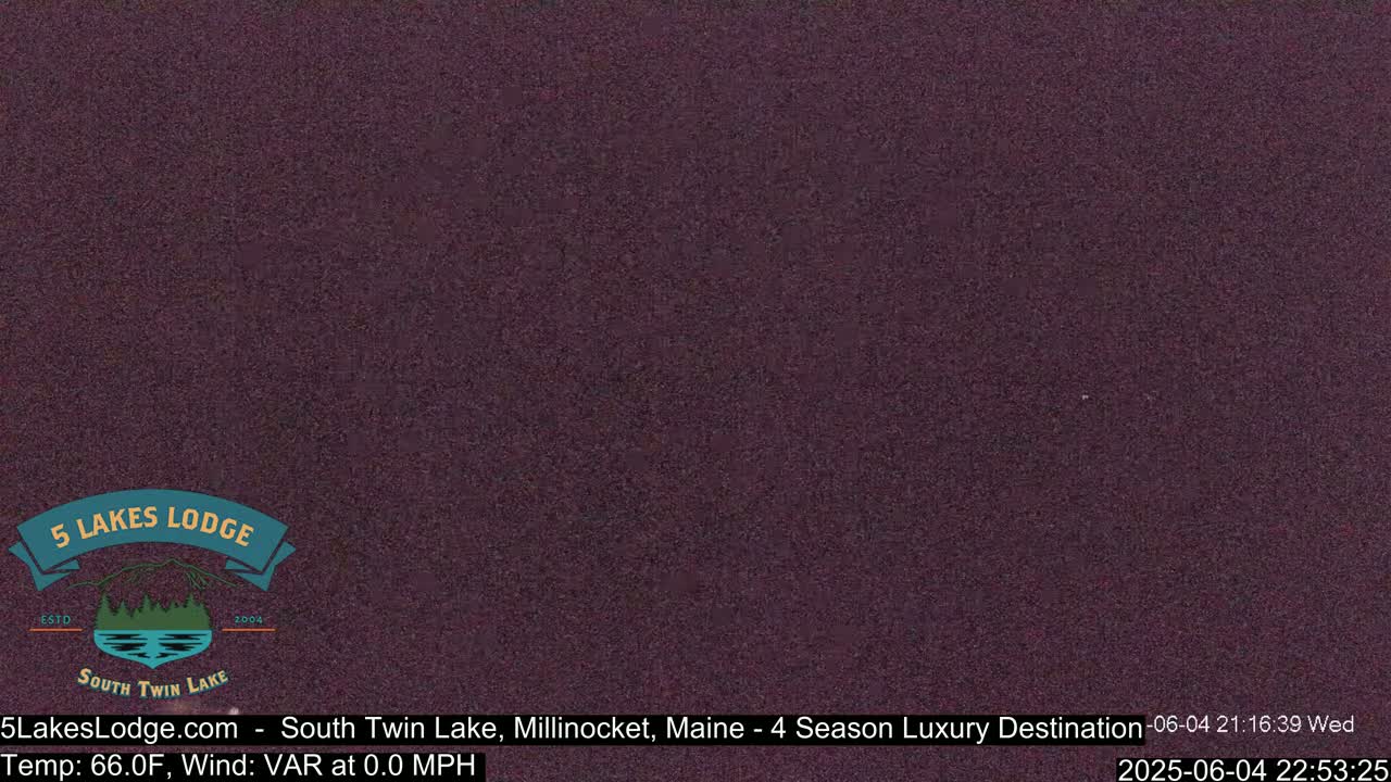 A dark purple, grainy image shows a nighttime scene with no discernible objects.