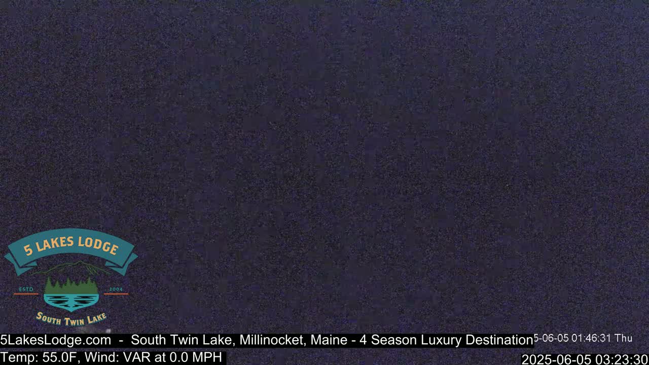 A dark, nighttime view of an outdoor scene with calm winds.