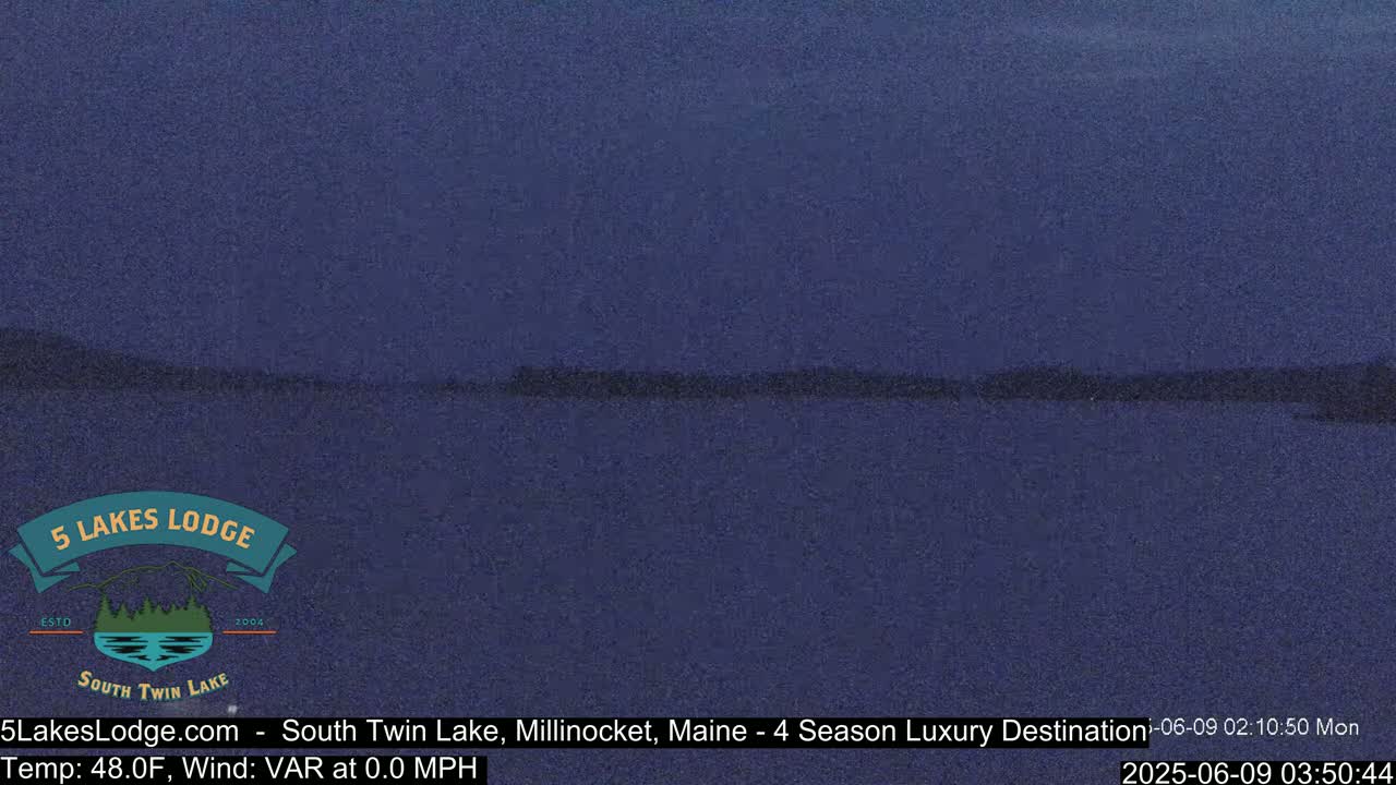 A dark blue lake is visible under a twilight sky.