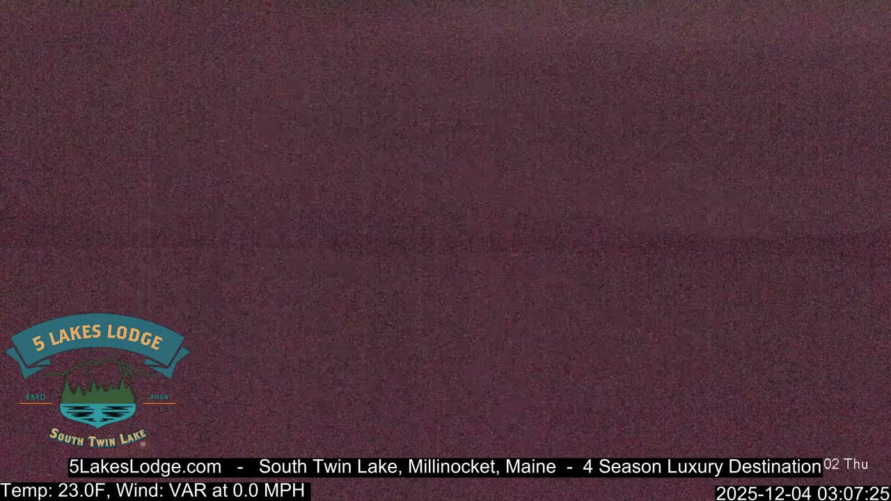 The image displays a very dark, heavily pixelated field of reddish-brown, with no discernible objects, scenery, or clear features.