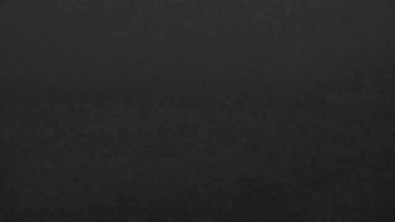 A dark gray or black textured surface is shown.