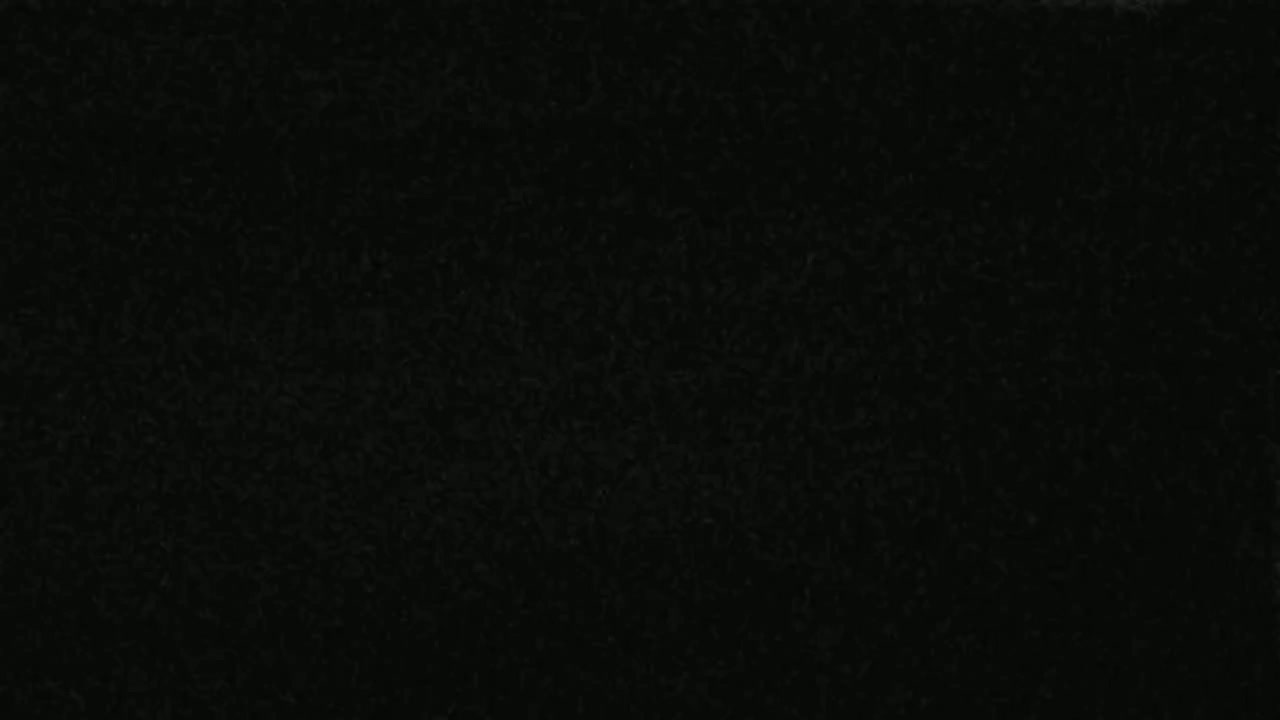 The image shows a dark, mottled surface that appears to be textured.