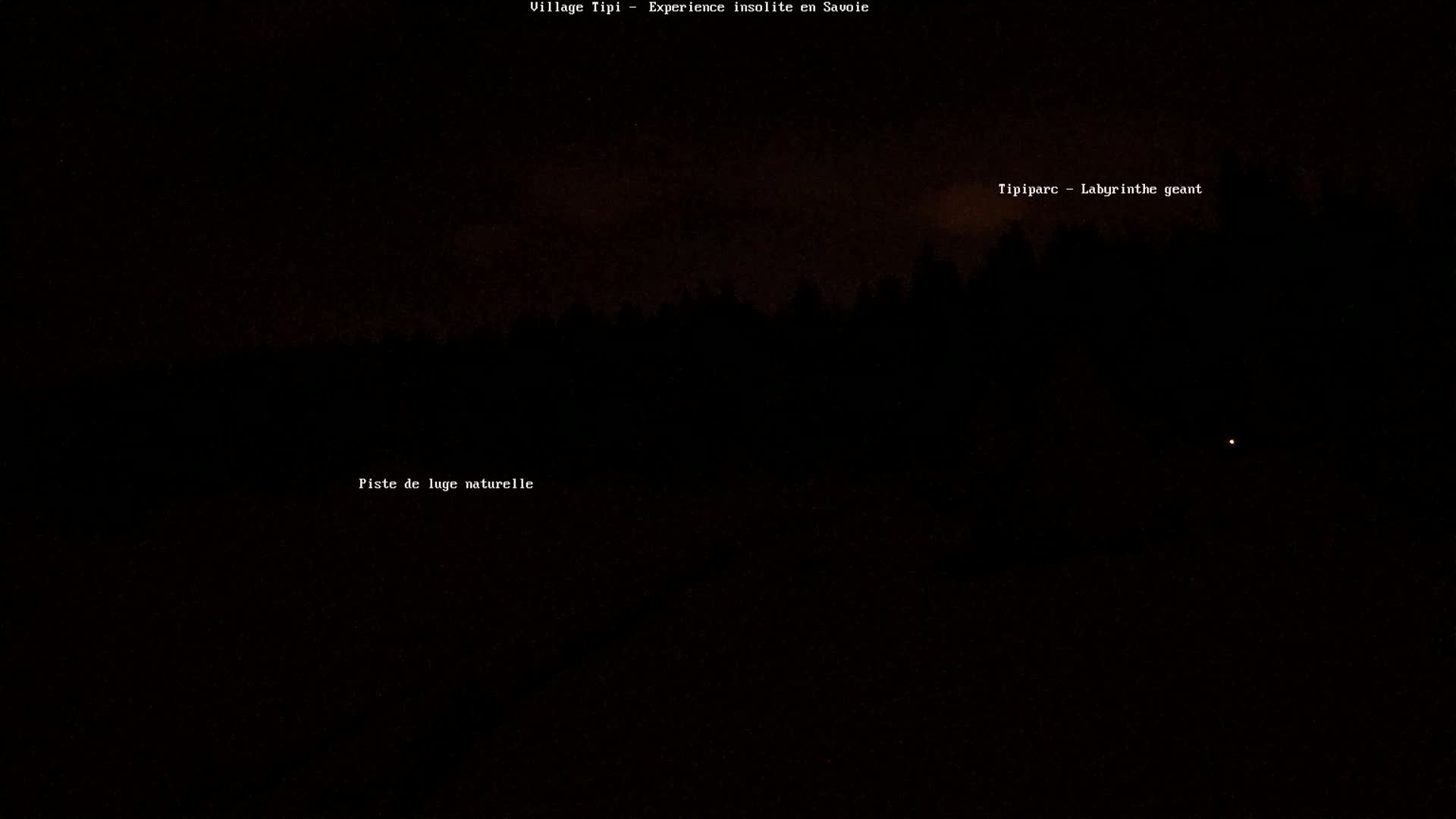 A dark, nighttime scene shows a silhouetted line of trees against a mostly clear sky with a single, distant light visible.
