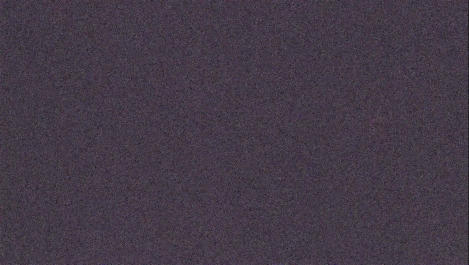 The image shows a textured, dark purplish-gray surface.