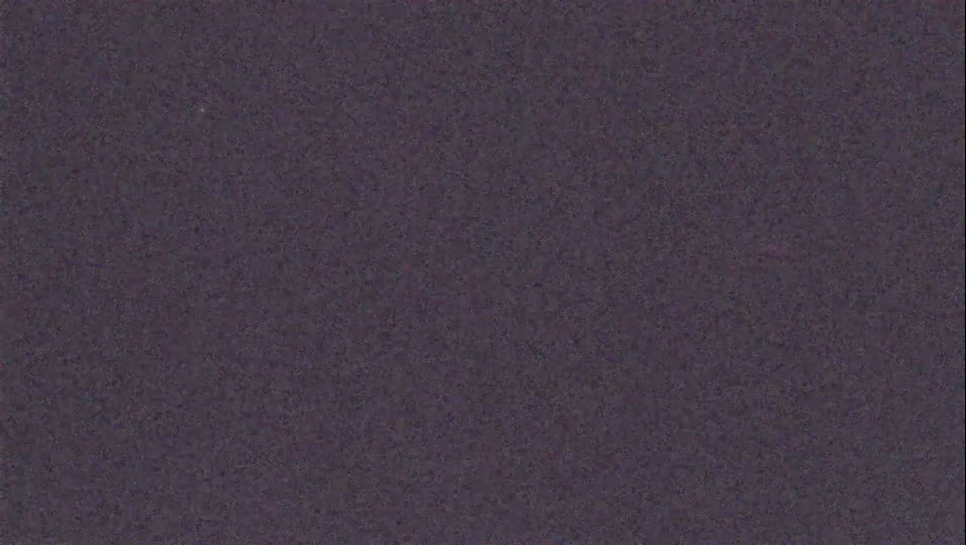 The image shows a textured, dark purplish-gray surface.