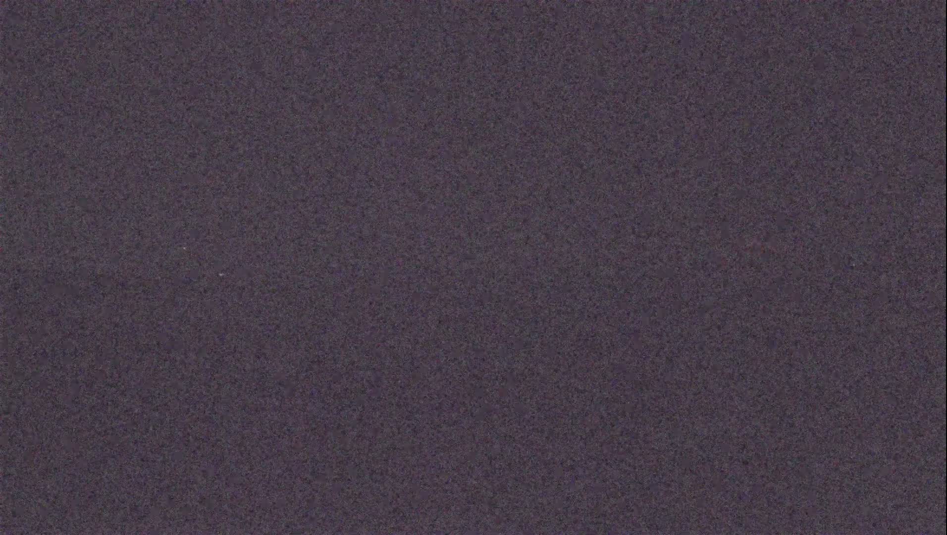 The image shows a dark purplish-gray textured surface.