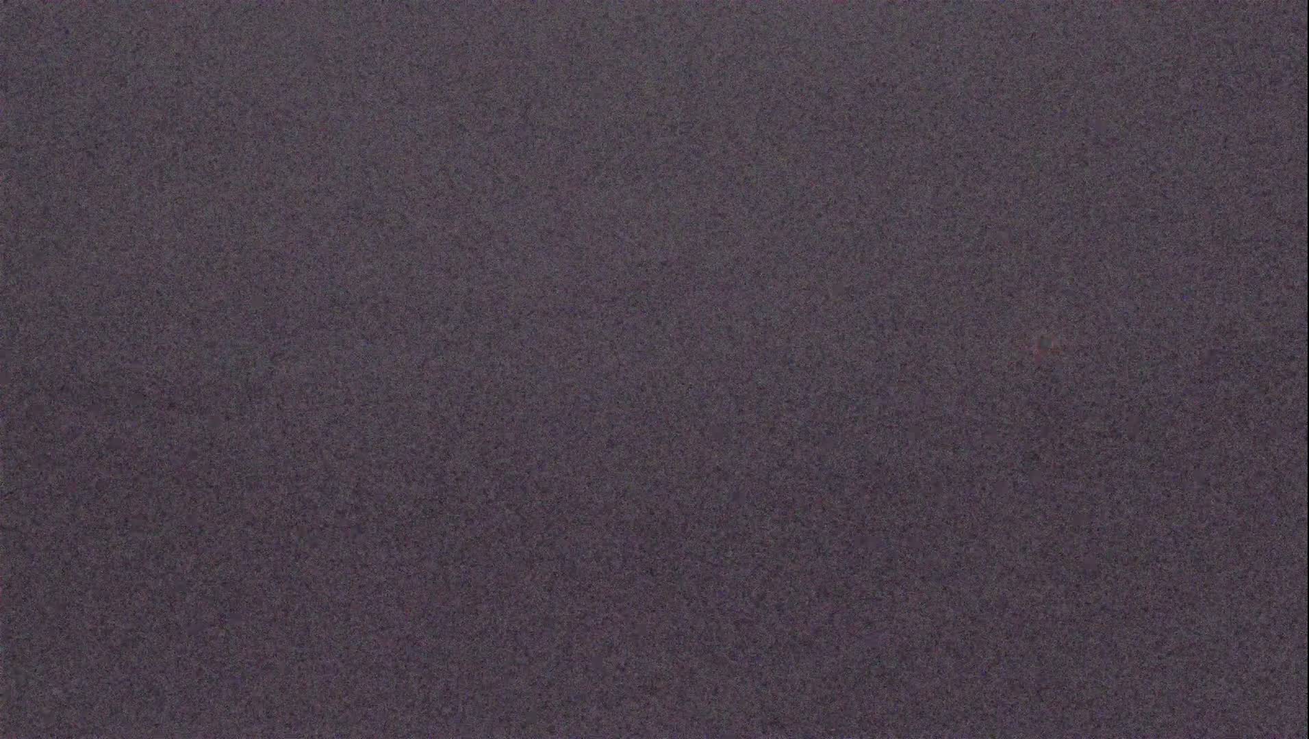 The image shows a dark gray, textured surface.
