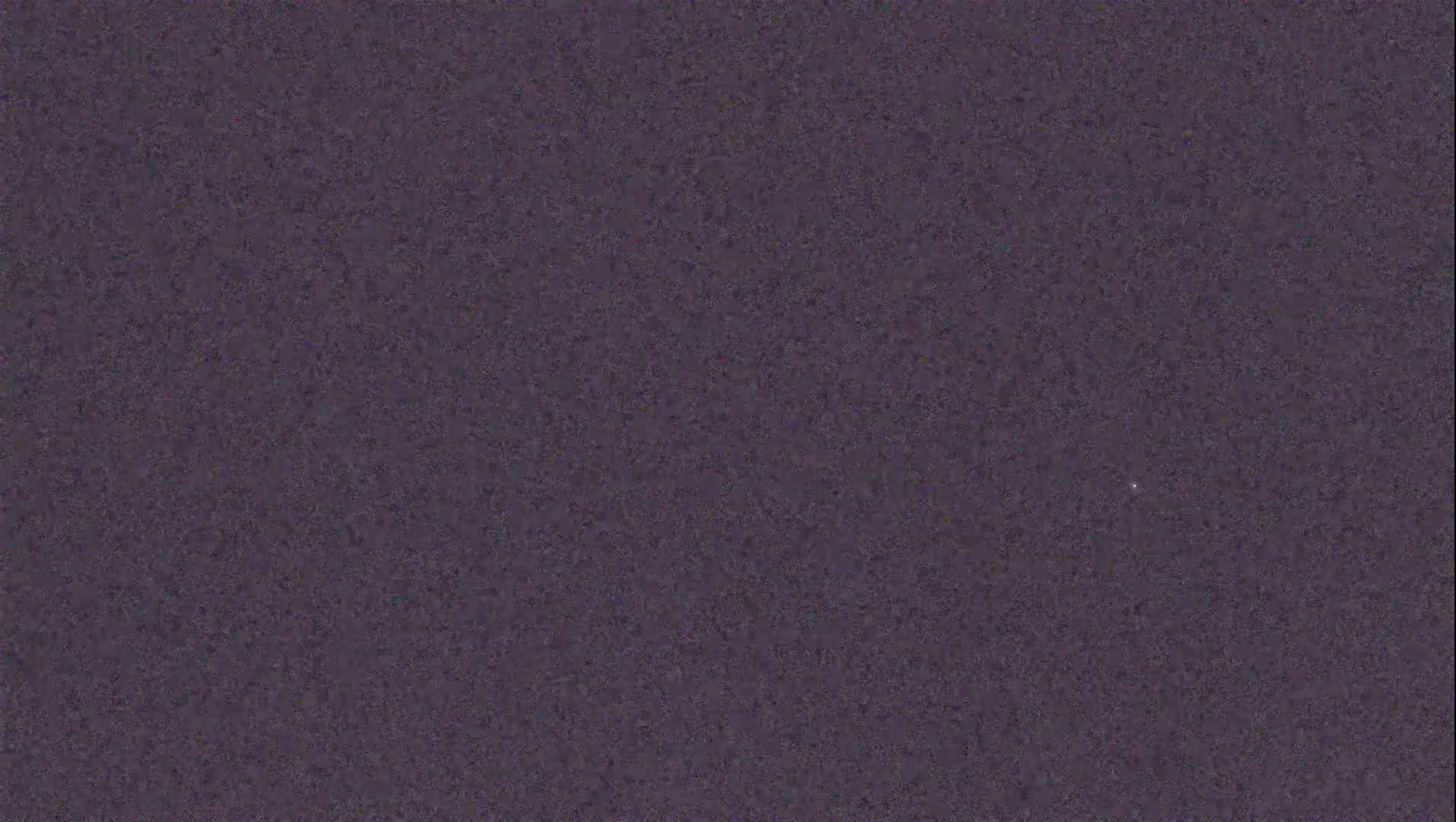 A uniformly textured dark purple surface is shown.