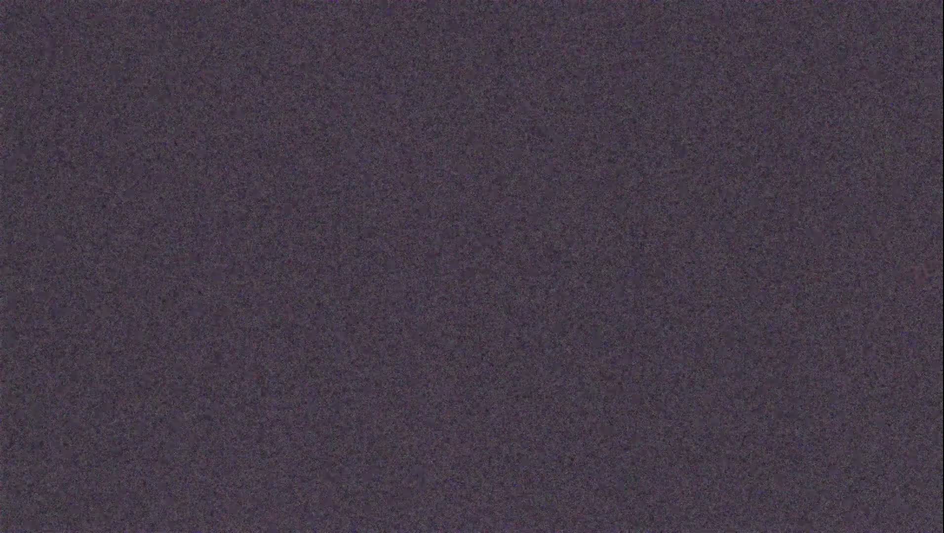 The image shows a textured, dark purplish-gray surface.