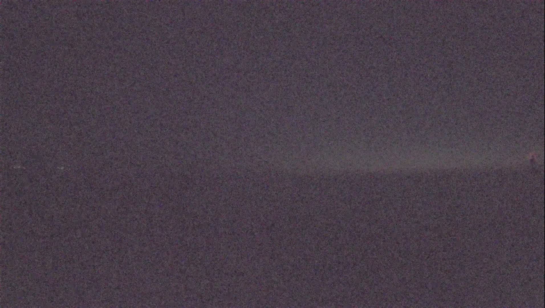 A grainy, dark purple image shows a blurry, indistinct horizon line.