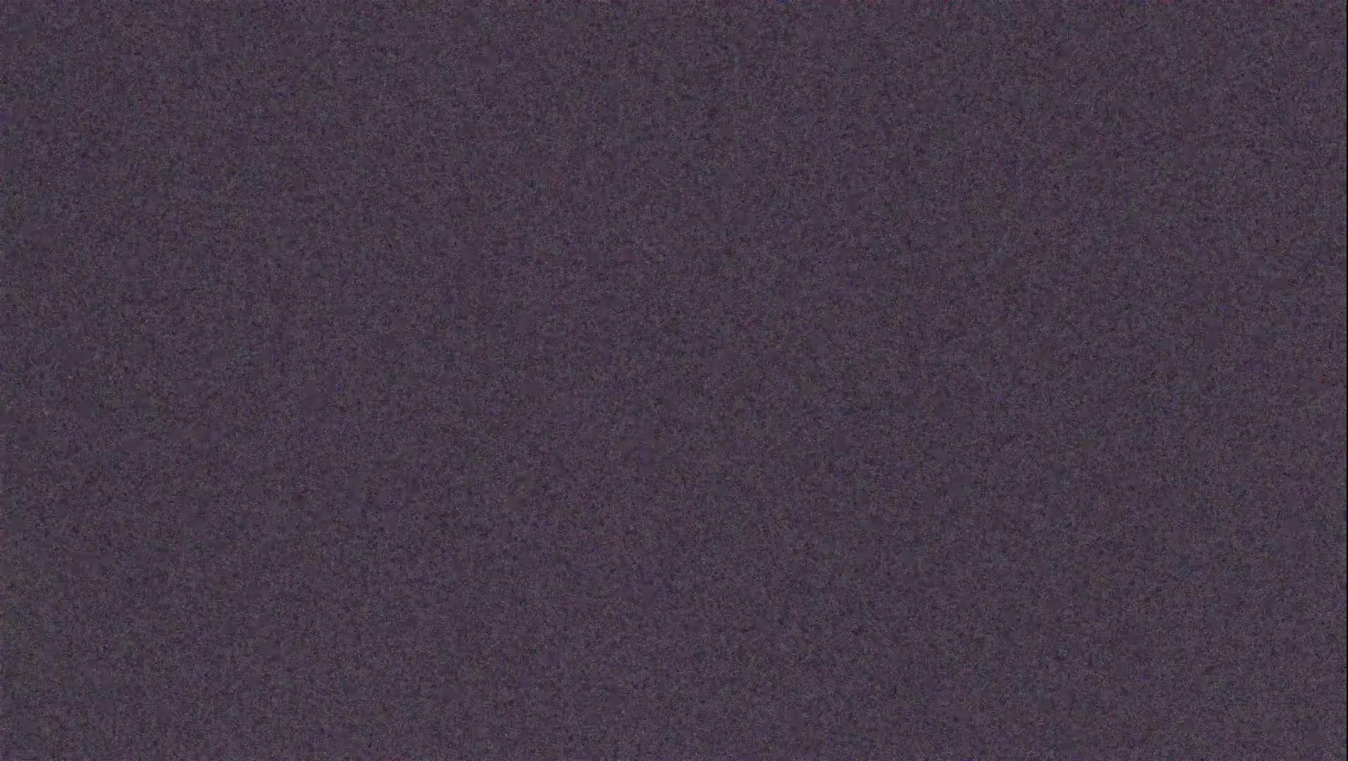 The image shows a dark purplish-grey textured surface.