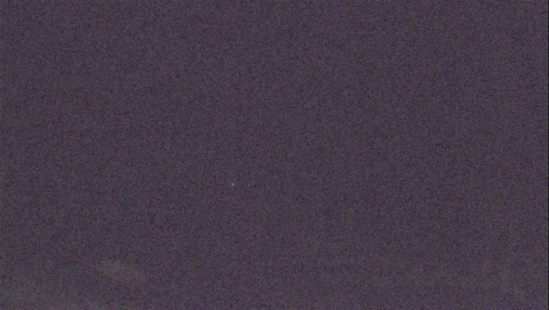 A dark purple or grayish-purple textured surface is shown, possibly a wall or fabric.