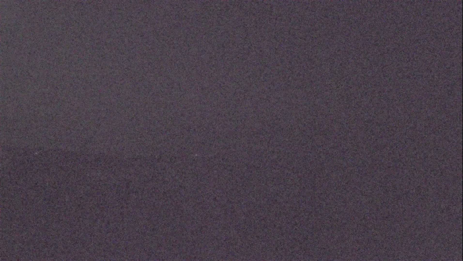 The image shows a uniformly textured, dark grayish-purple surface.