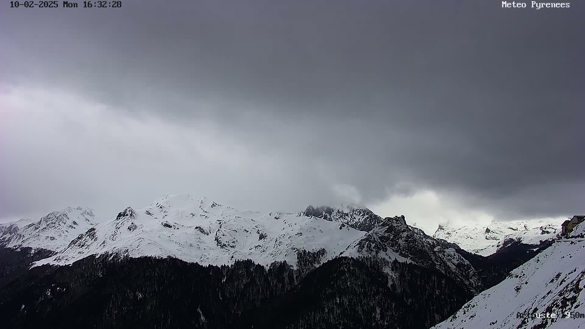 Snow-covered mountains are visible under an overcast sky.