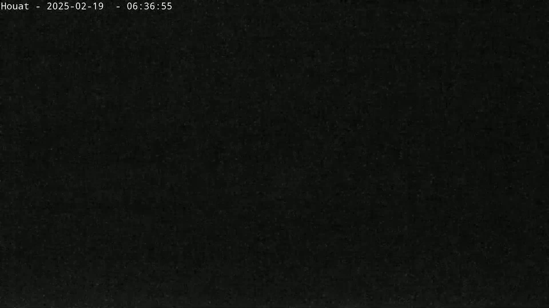 A very dark, grainy image shows mostly black.