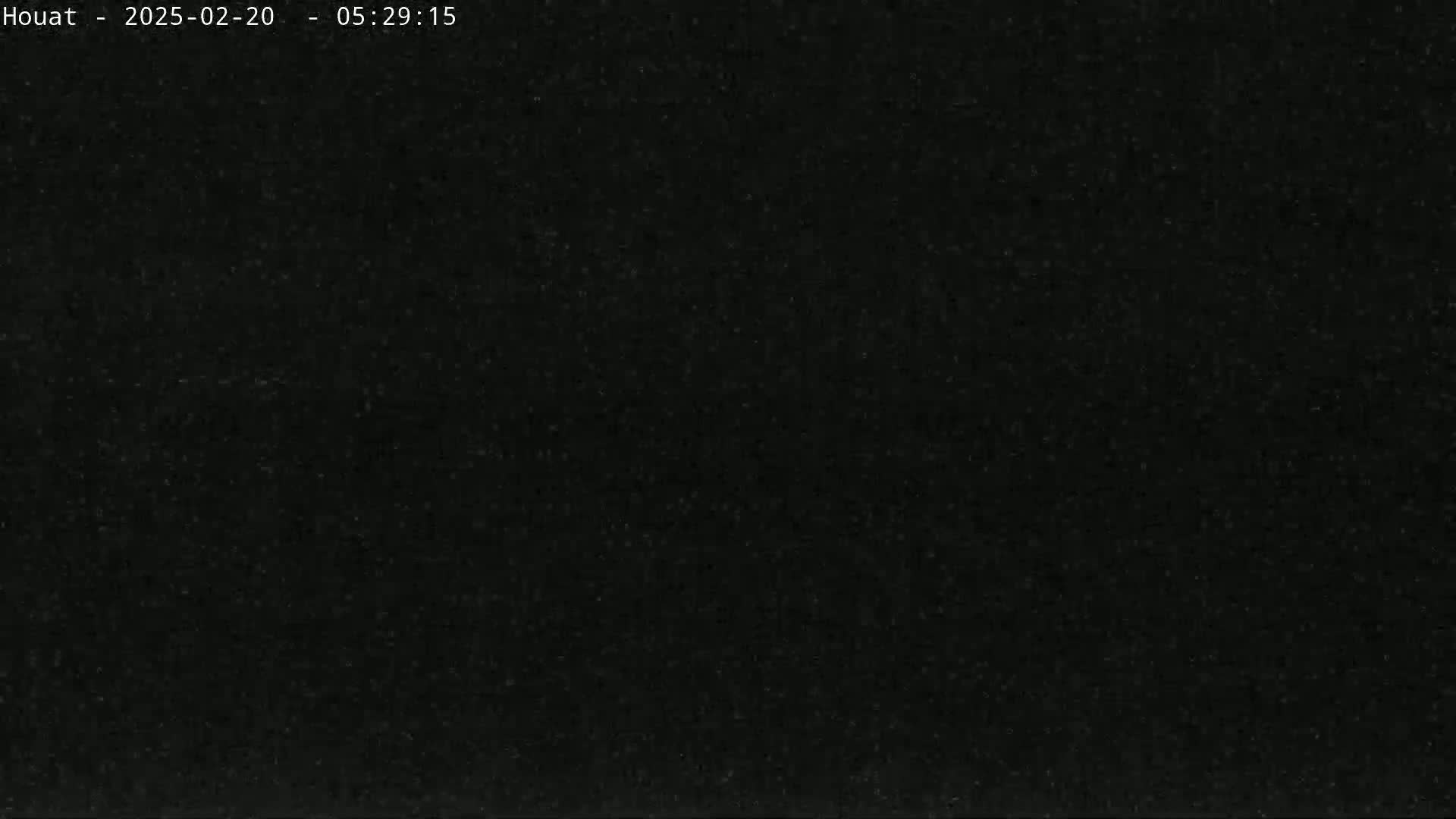 The image shows a dark, grainy black surface.