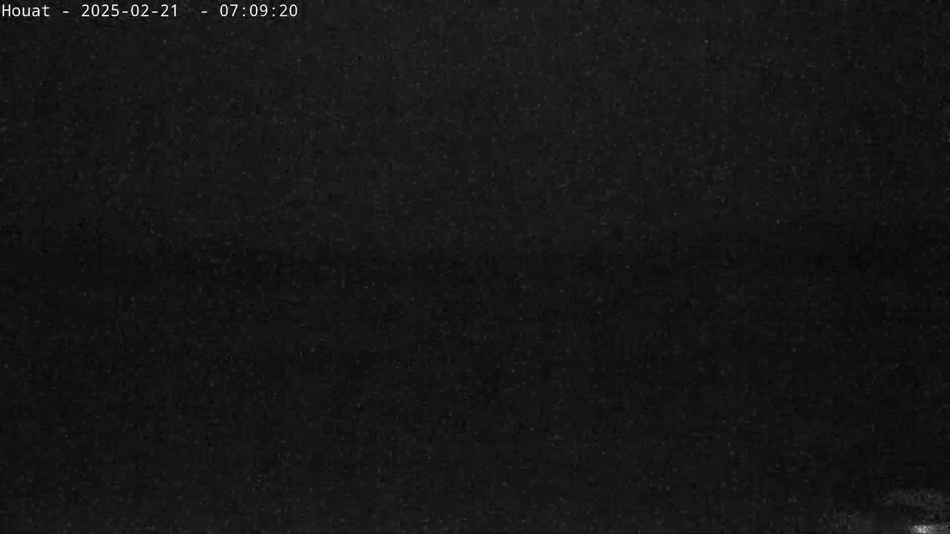 The image shows a completely dark, grainy view.