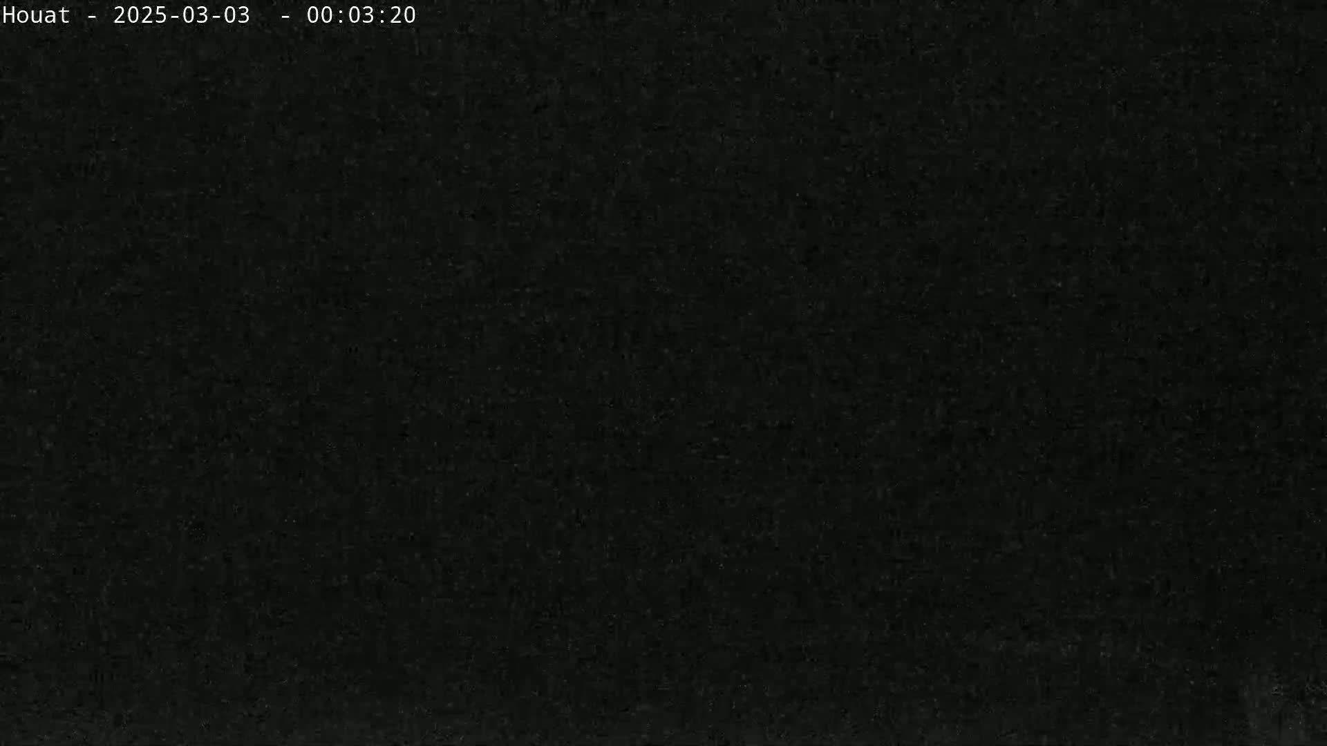 The image is a completely dark, grainy black screen.