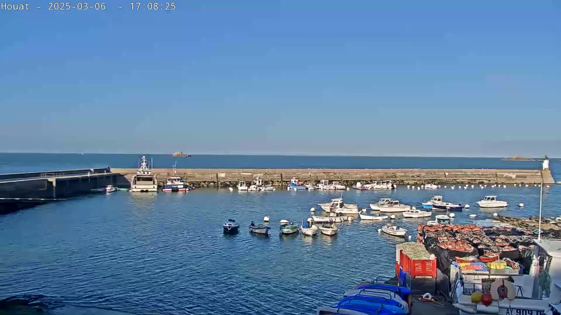 A harbor filled with numerous small boats under a clear blue sky.