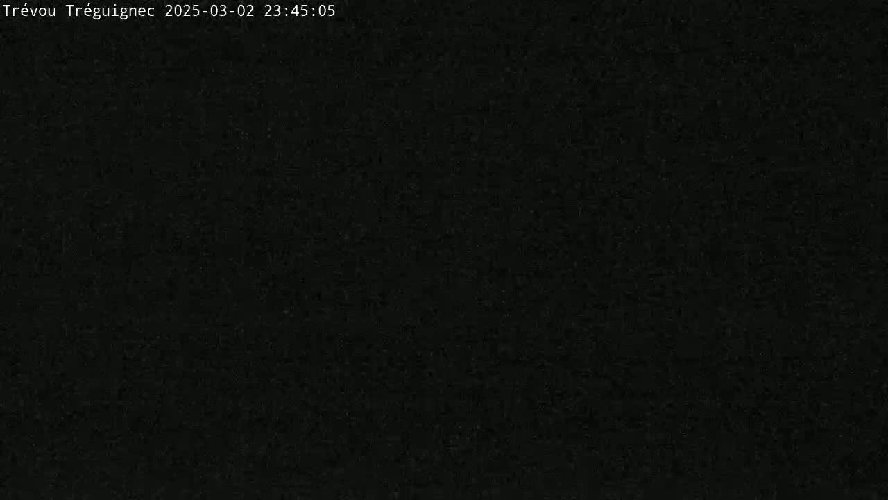 The image is a completely dark, grainy black screen.