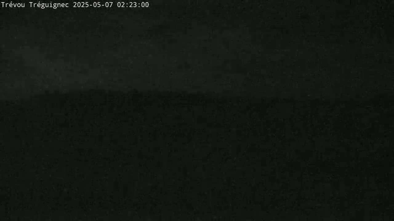 A dark, possibly nighttime, outdoor scene shows a mostly featureless black expanse.