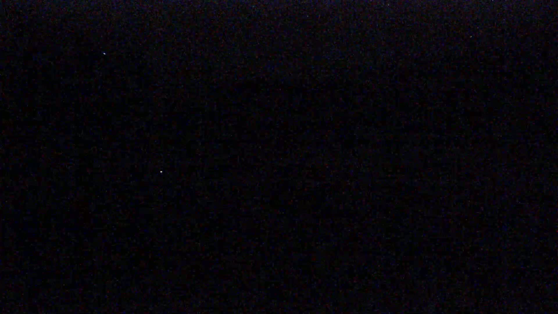 A dark night sky shows a few faint stars.