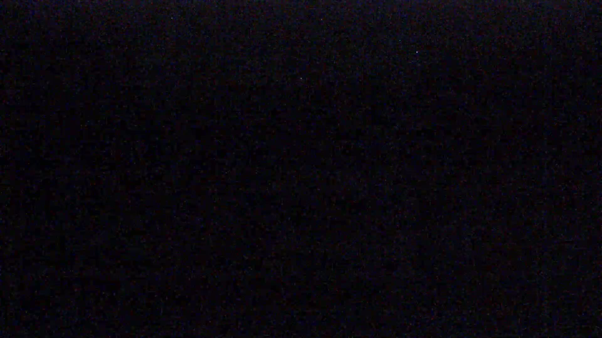 The image is a completely black screen with slight variations in shade.