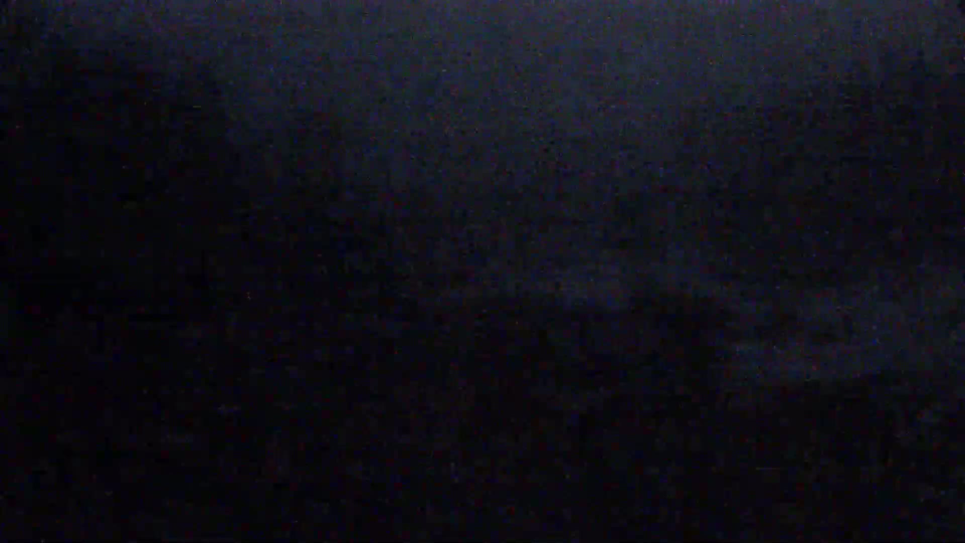 The image shows a dark, possibly nighttime scene with a grainy texture.