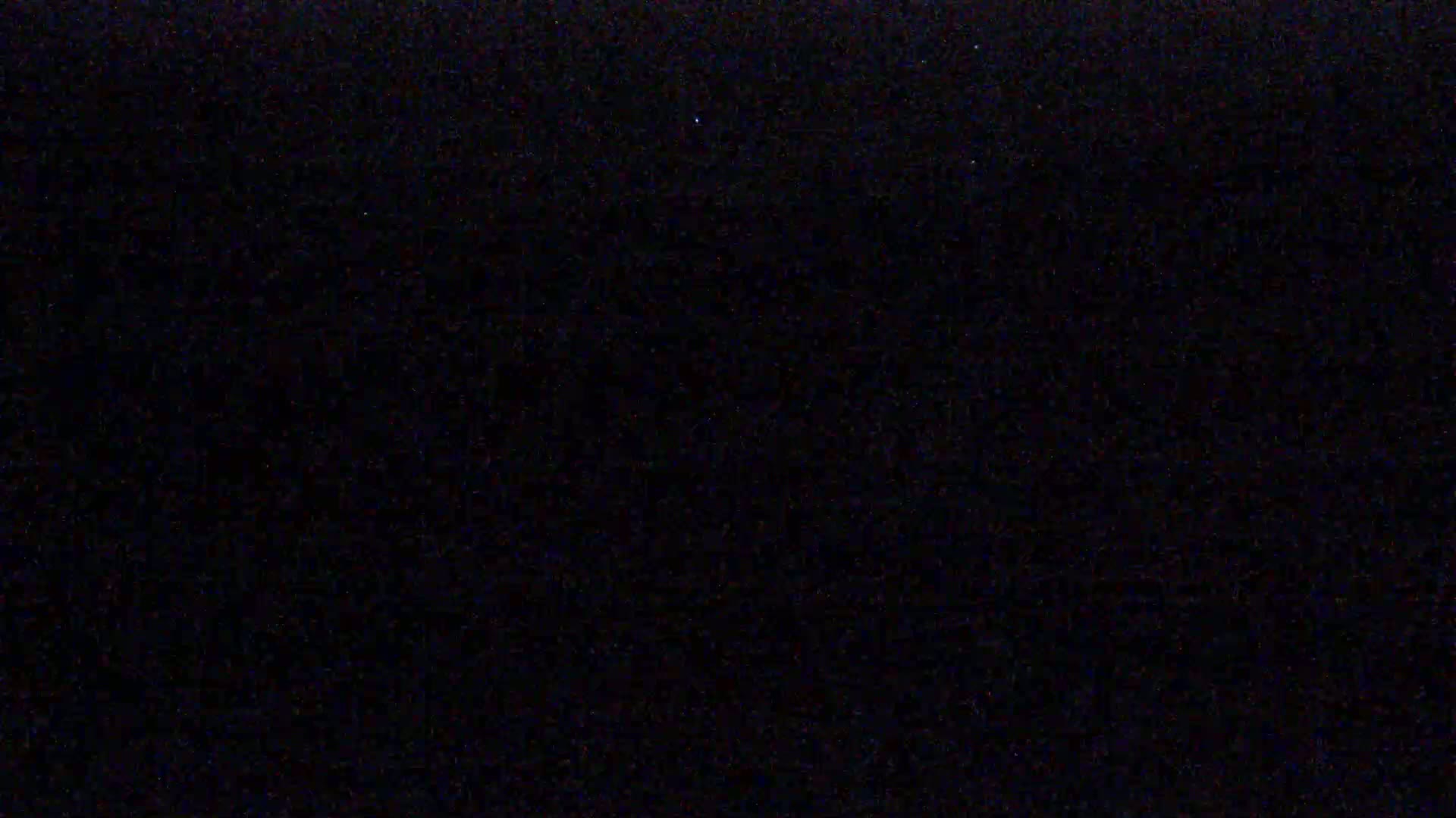 The image shows a completely dark, possibly nighttime scene.