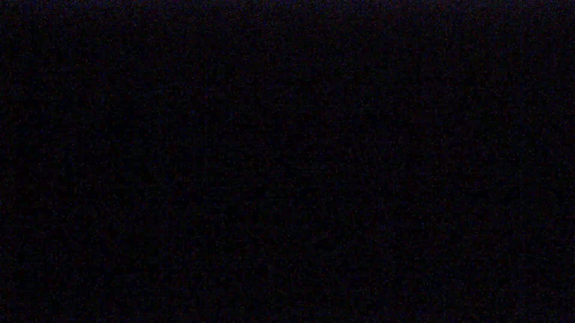 The image is a completely black field with some very faint speckles of color.