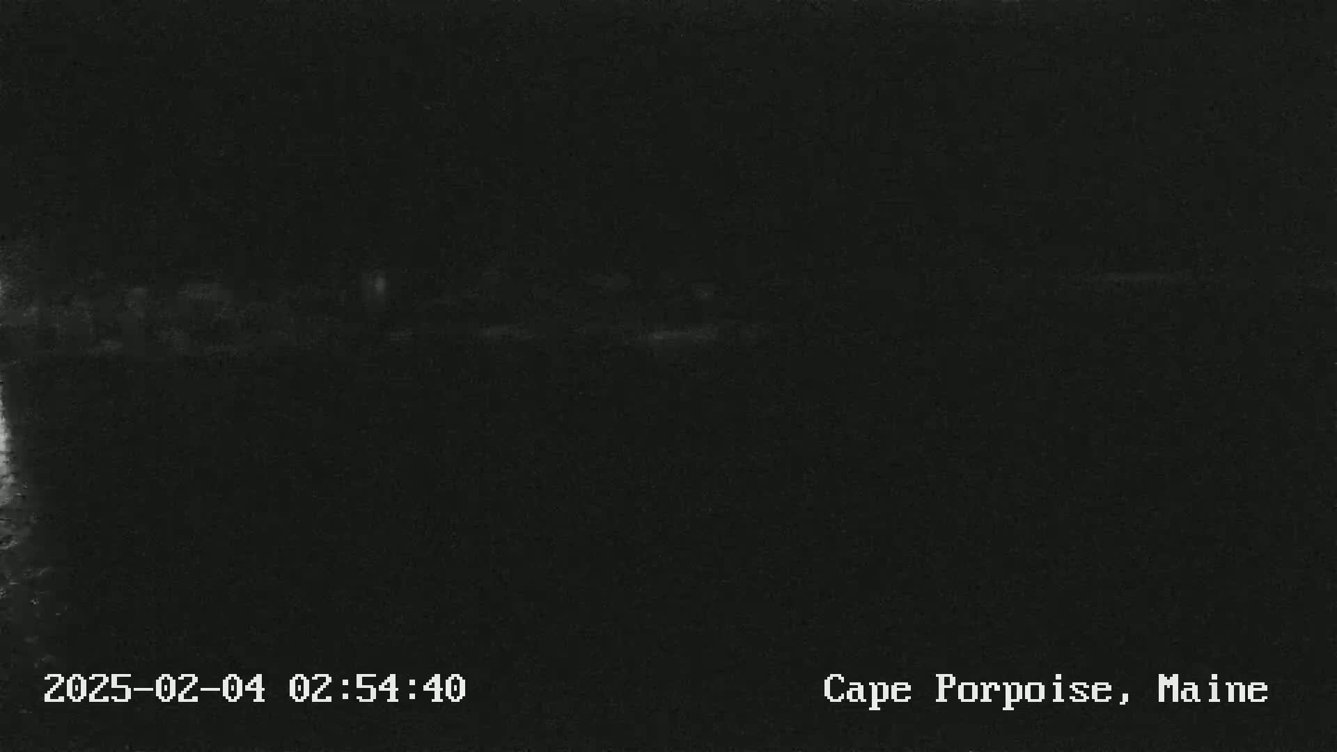 A dark, nighttime image shows a blurry, indistinct horizon line.