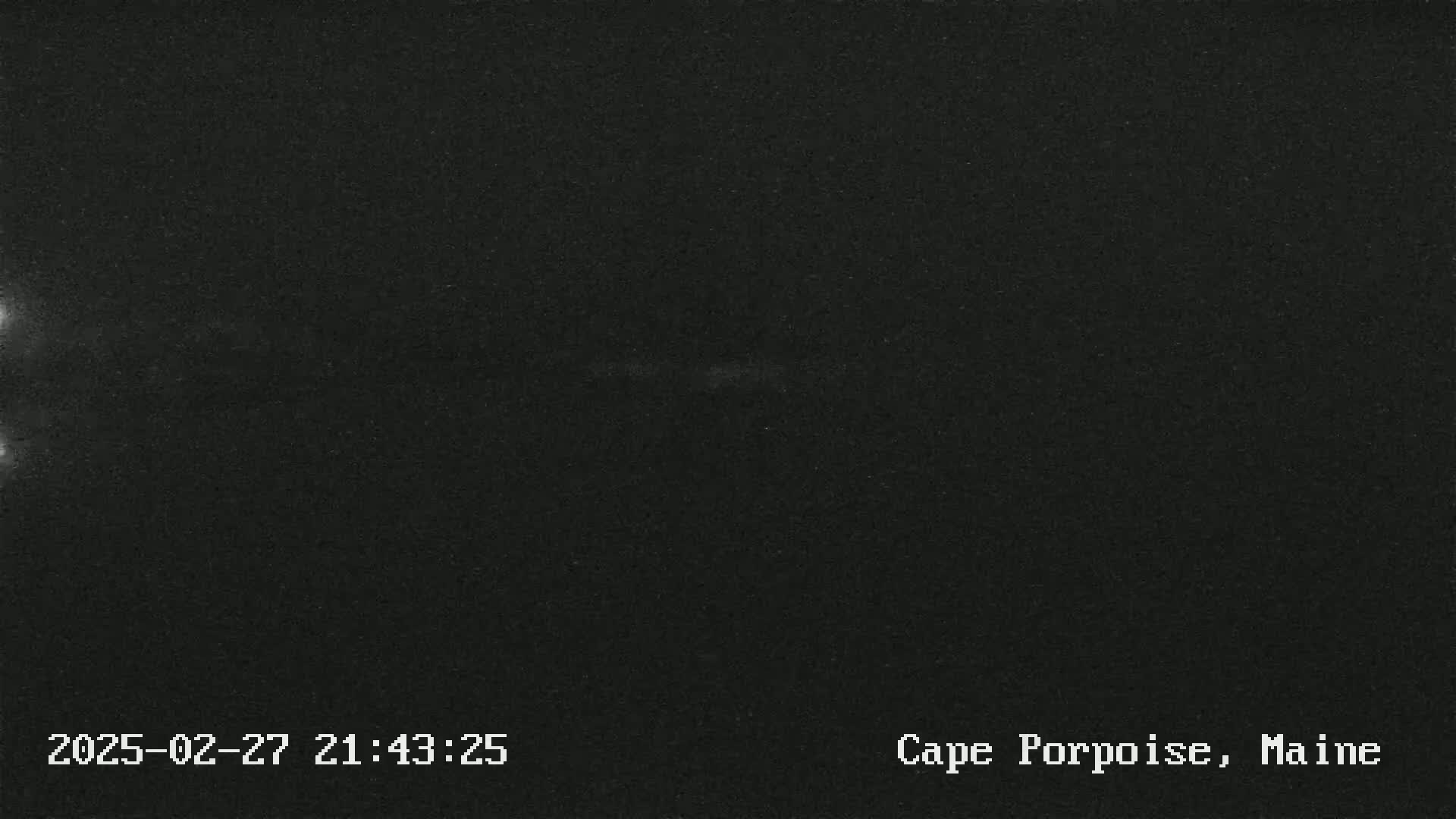 A dark, nighttime image shows a mostly black sky with faint, light streaks.
