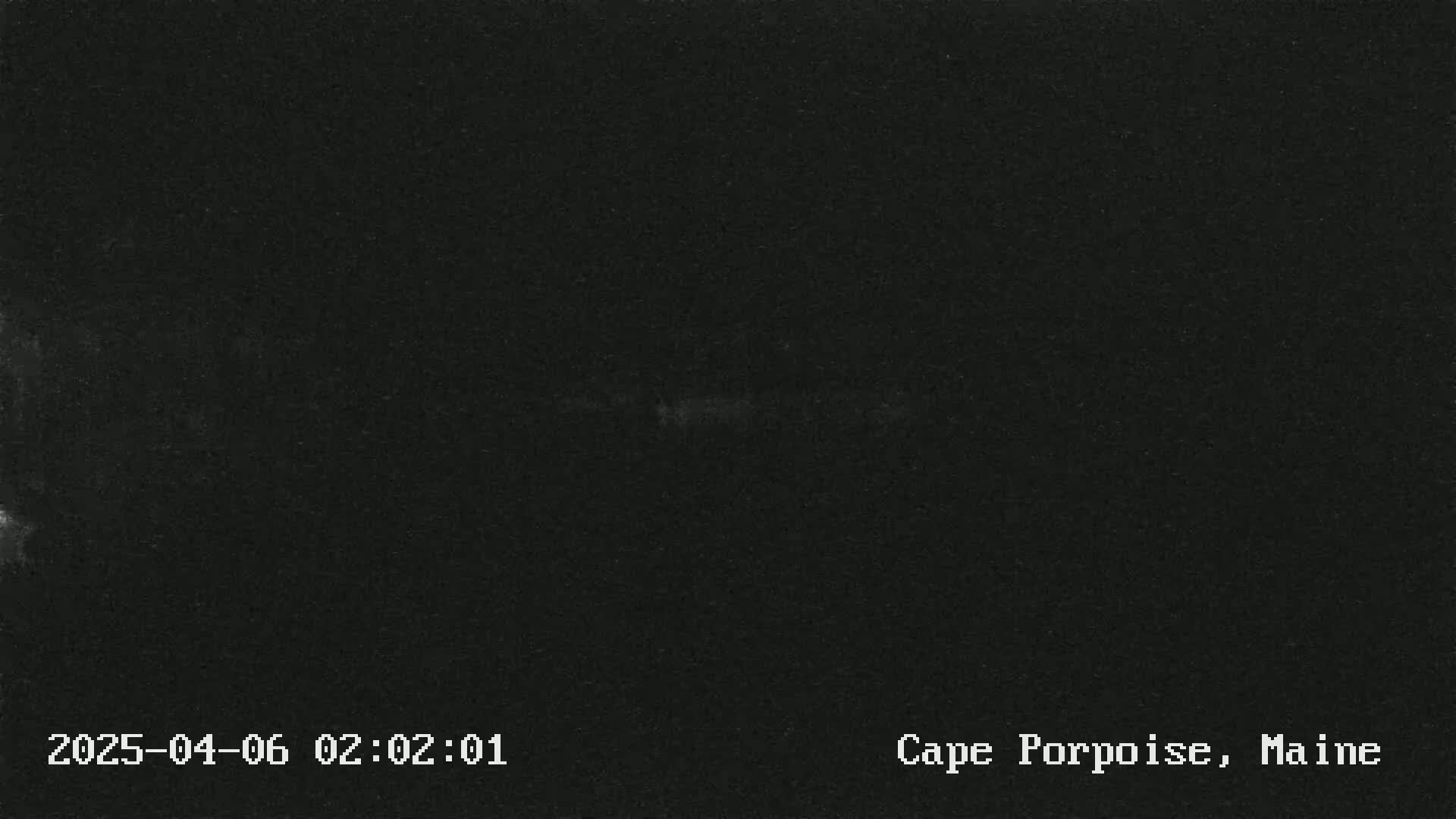 A dark, mostly featureless image suggests nighttime conditions.