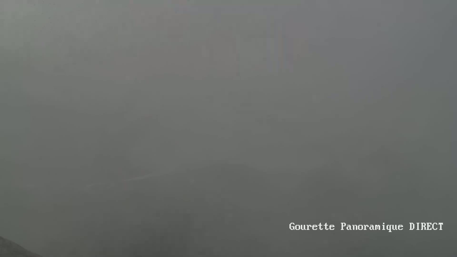 A very foggy, gray landscape is visible.