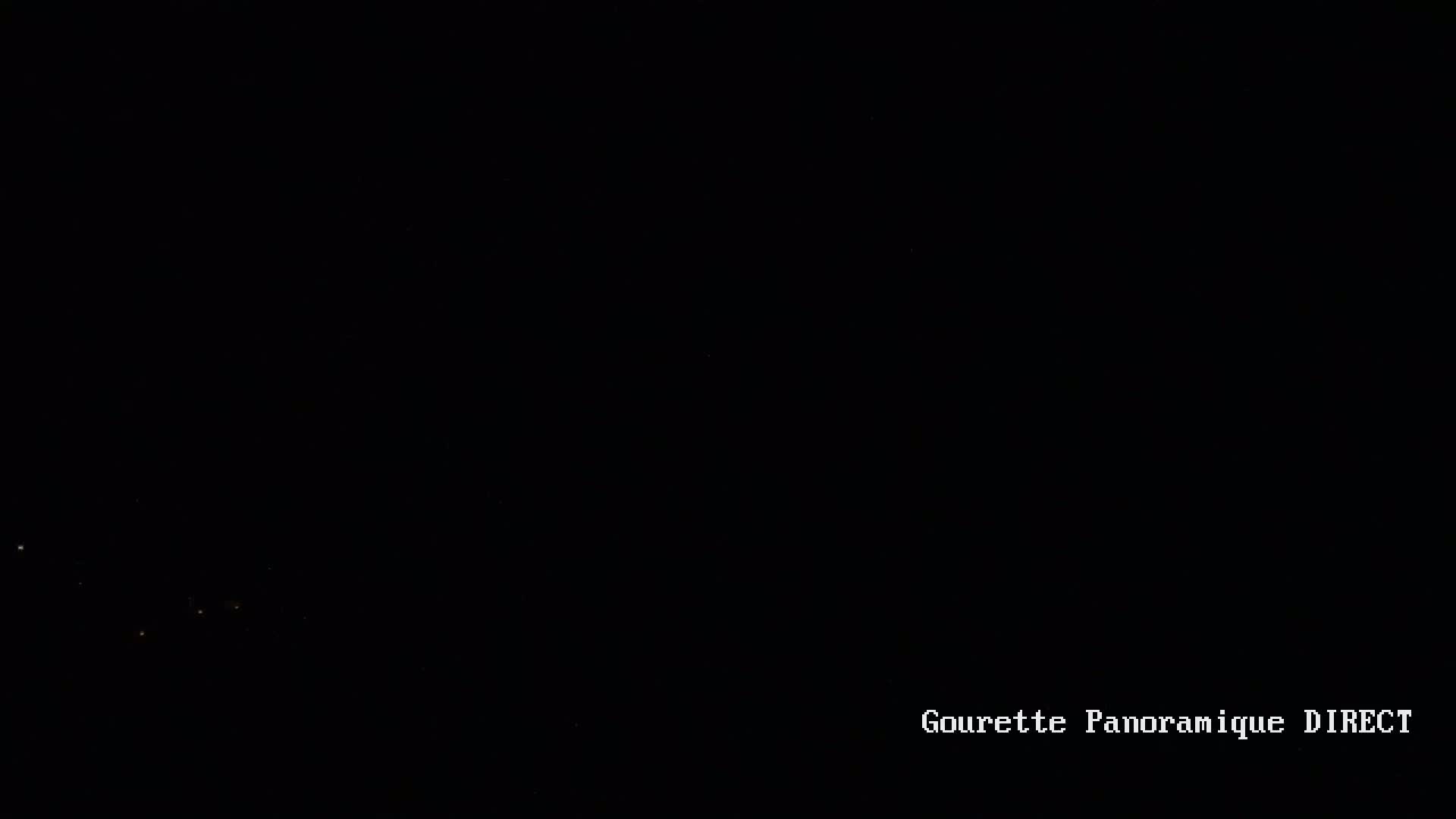 A dark nighttime scene shows a few faint lights in the distance under a clear, starlit sky.