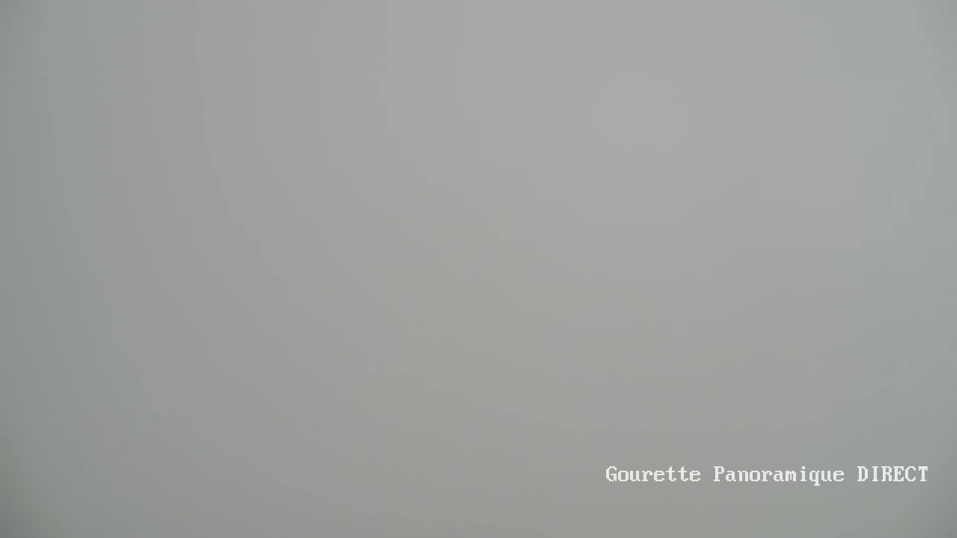 A long-range view shows a mountain range under a clear, light-blue sky.