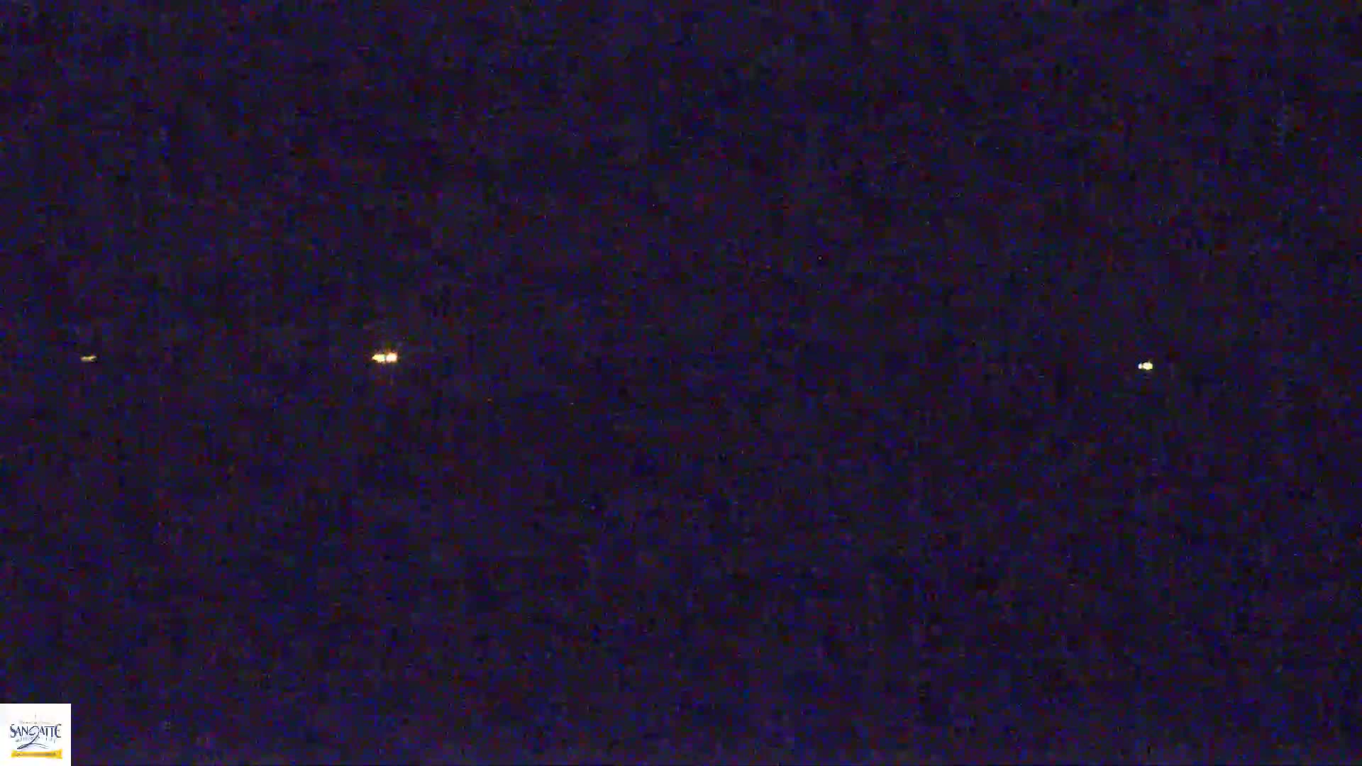 Several faint lights are visible in the night sky.