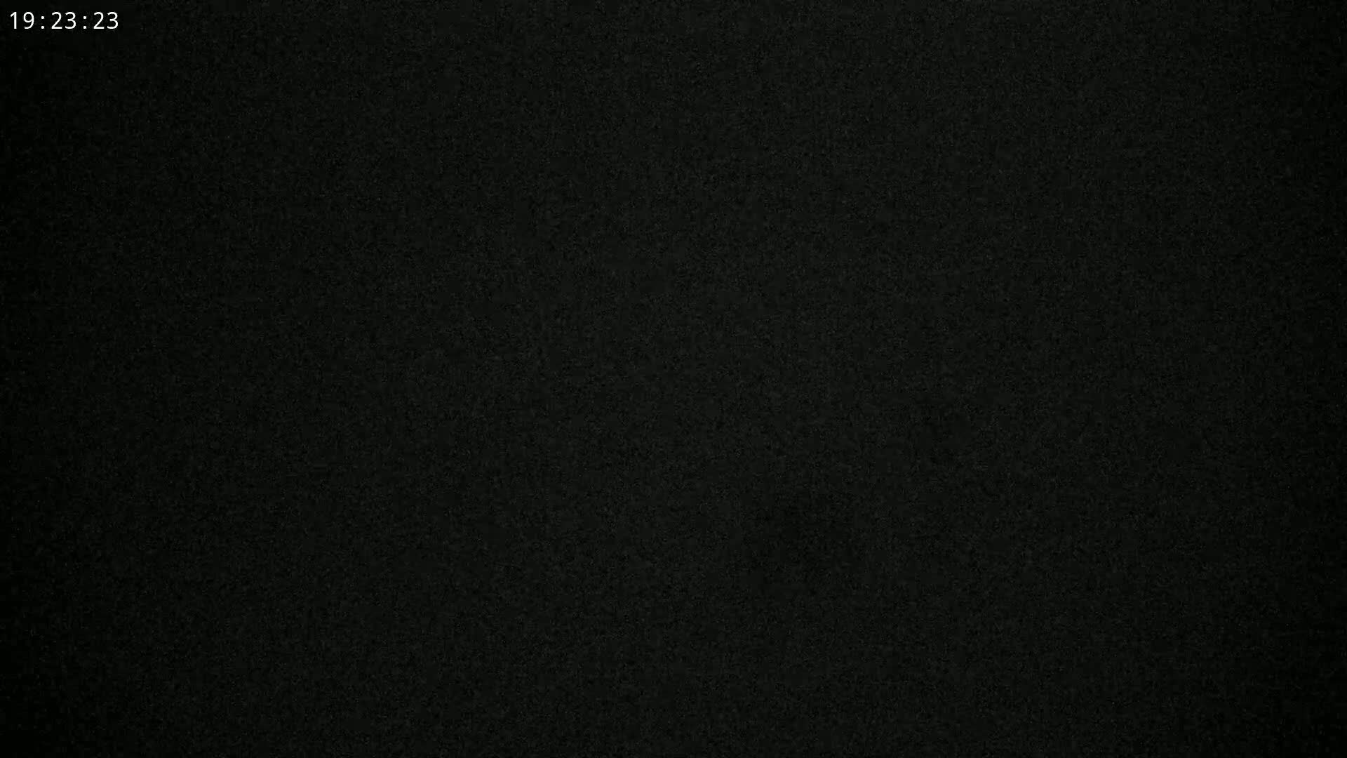 The image is a completely dark, grainy, black surface.