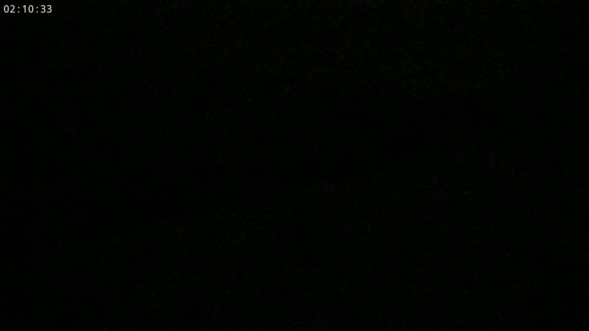 The image shows an extremely dark, almost entirely black, scene.