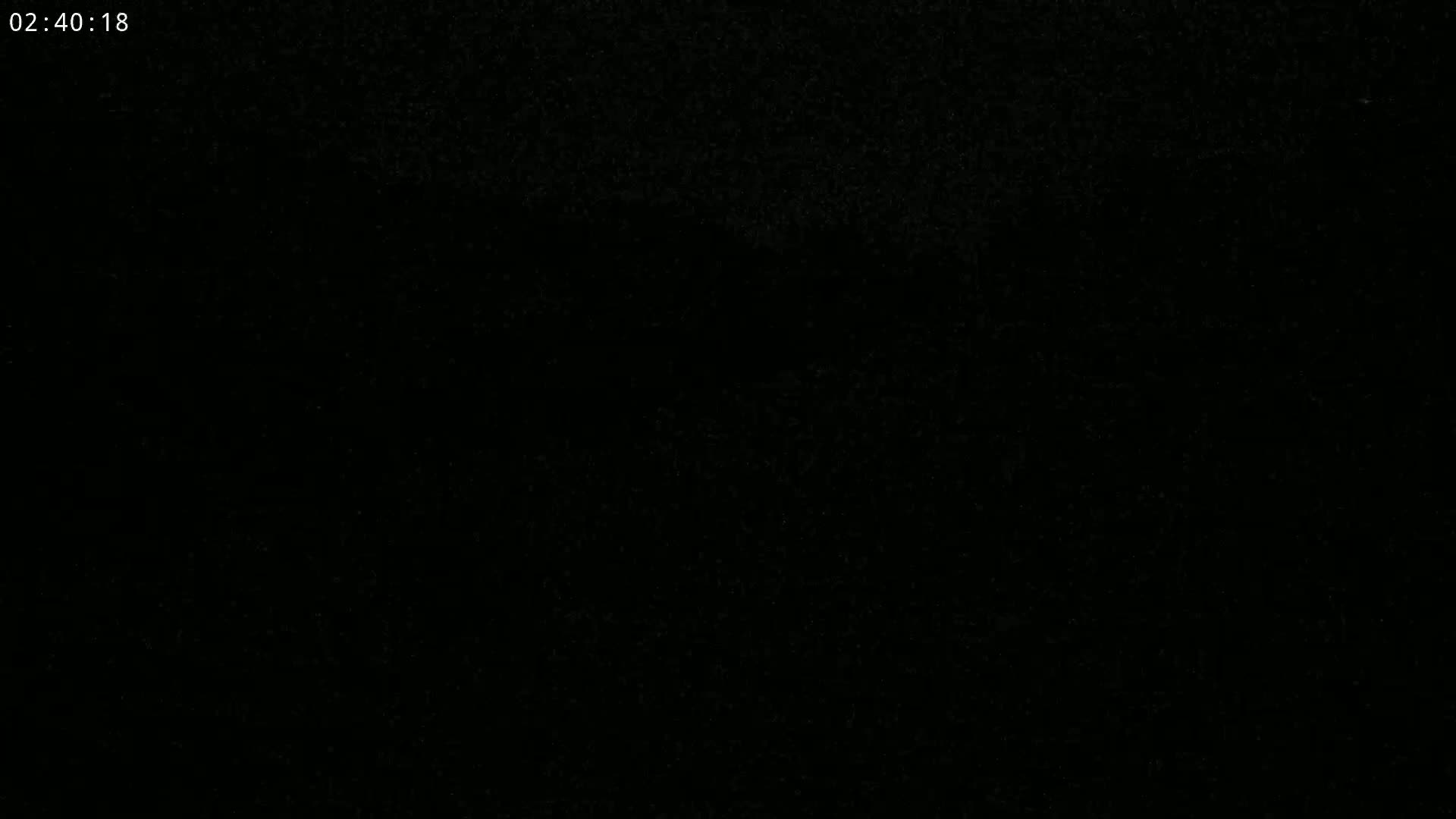 The image is completely black, possibly showing a nighttime scene with very poor visibility.