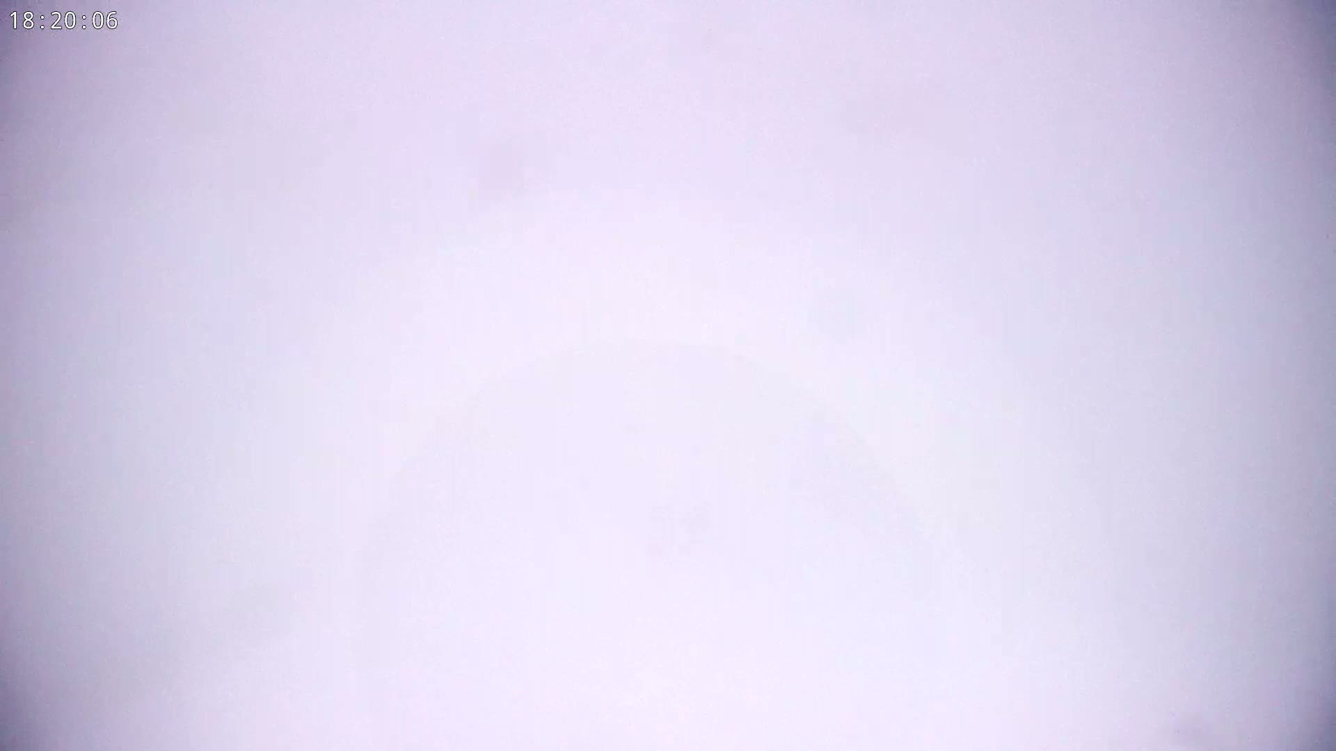 A mostly clear, light lavender sky is visible.